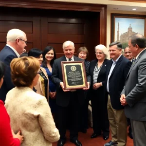 Community members gathered for Dr. Jermaine Whirl Day celebration with a plaque.