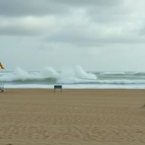 High waves and warning flags at a beach affected by Hurricane Erin