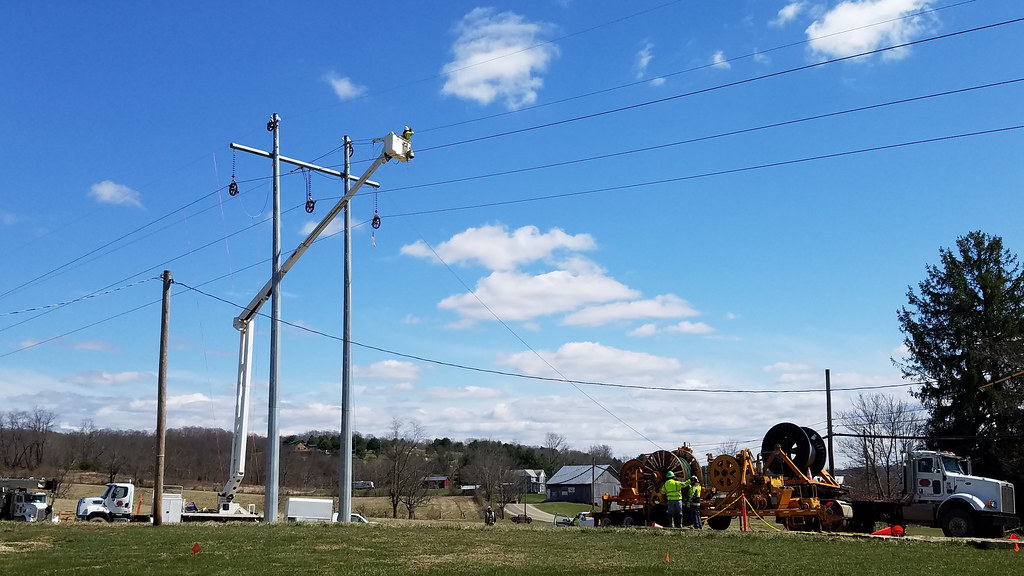 Utility power lines against a cloudy sky