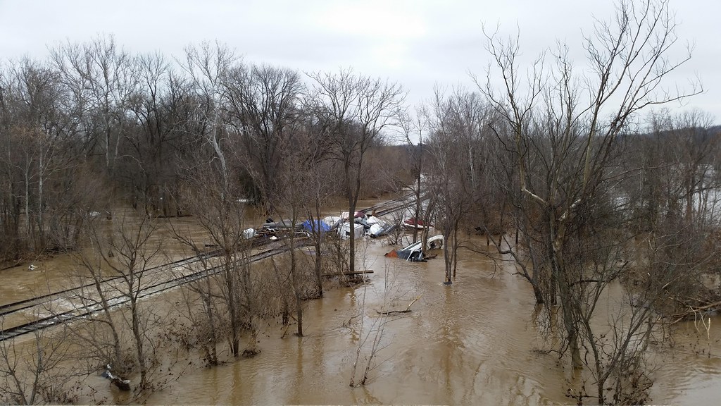 Flooded roadway with standing water after heavy rain